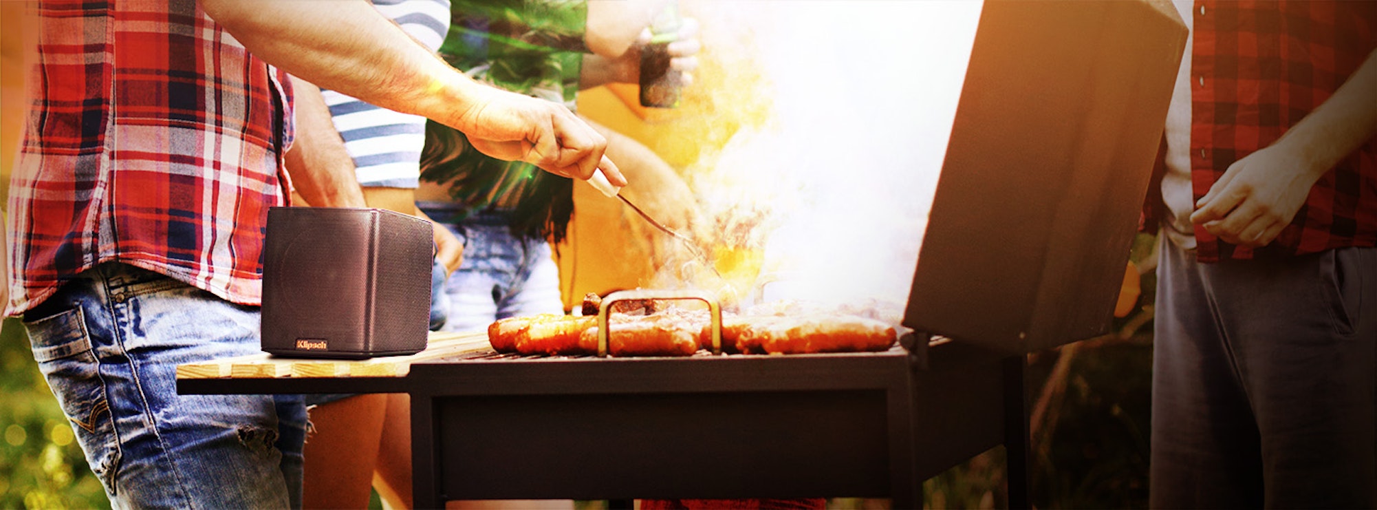 Groove on a grille while a man cooks hot dogs